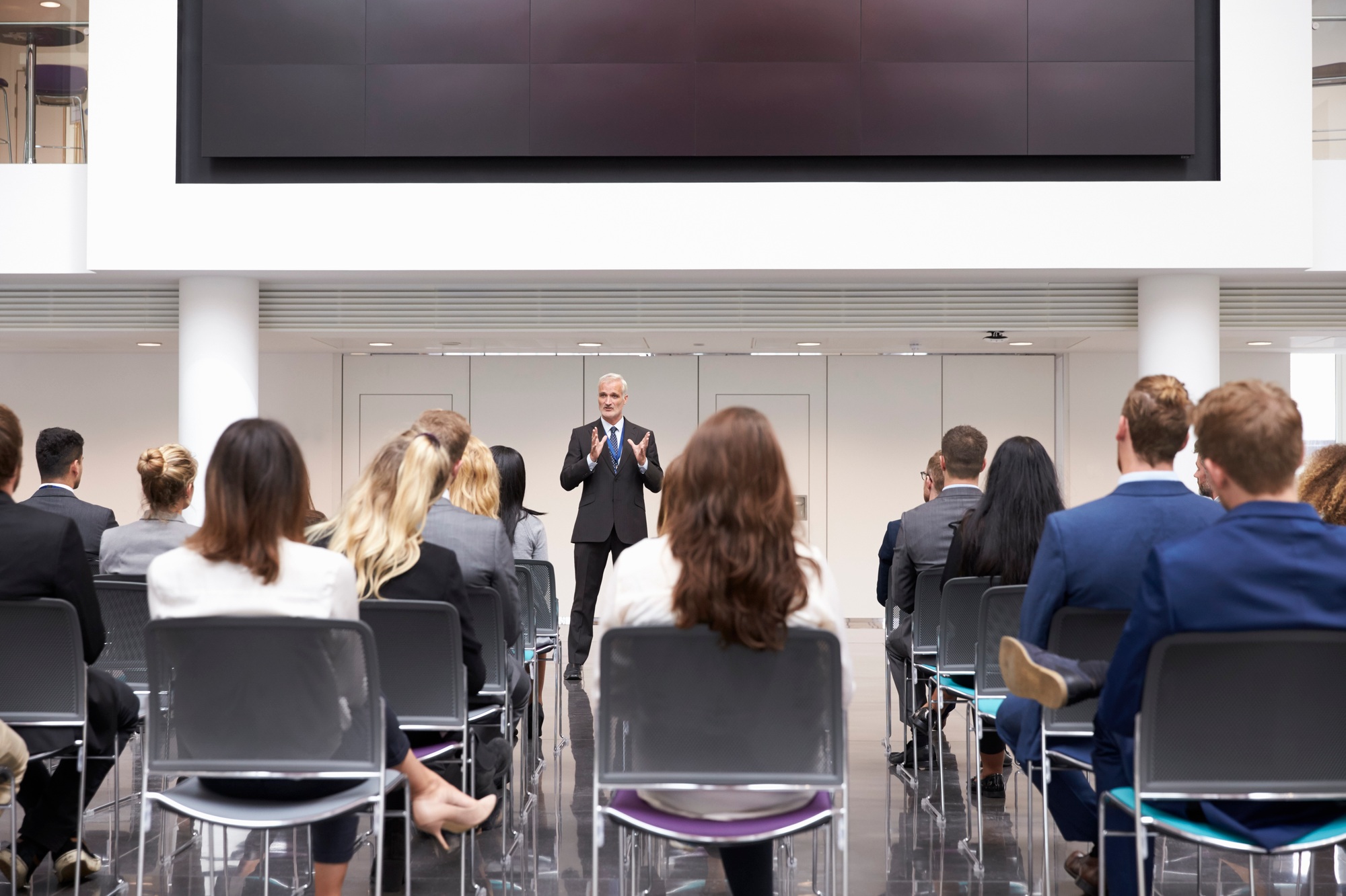 Mature Businessman Making Presentation At Conference